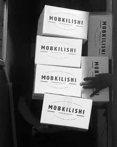Boxes of MobKilishi's Classic Beef Kilishi, showcasing the sun-dried, spicy Nigerian beef jerky.